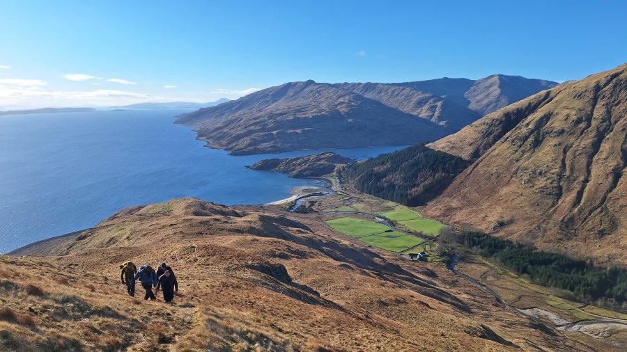 A small group climbing a hillside